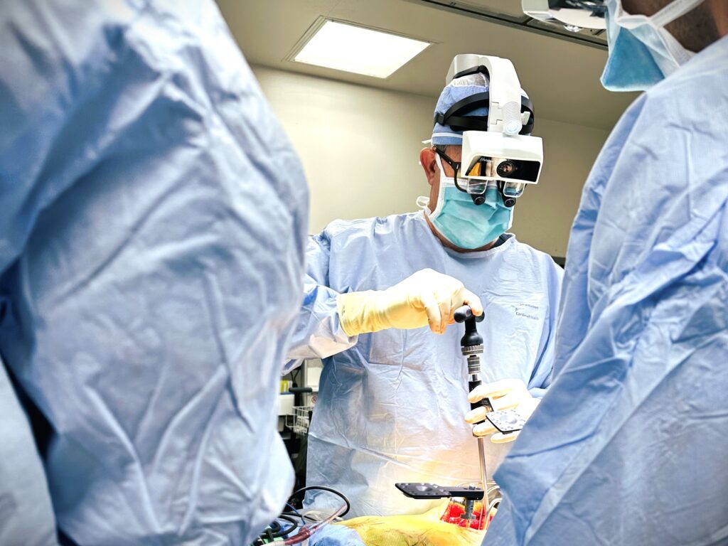 A surgeon uses an AR headset to perform spine surgery.